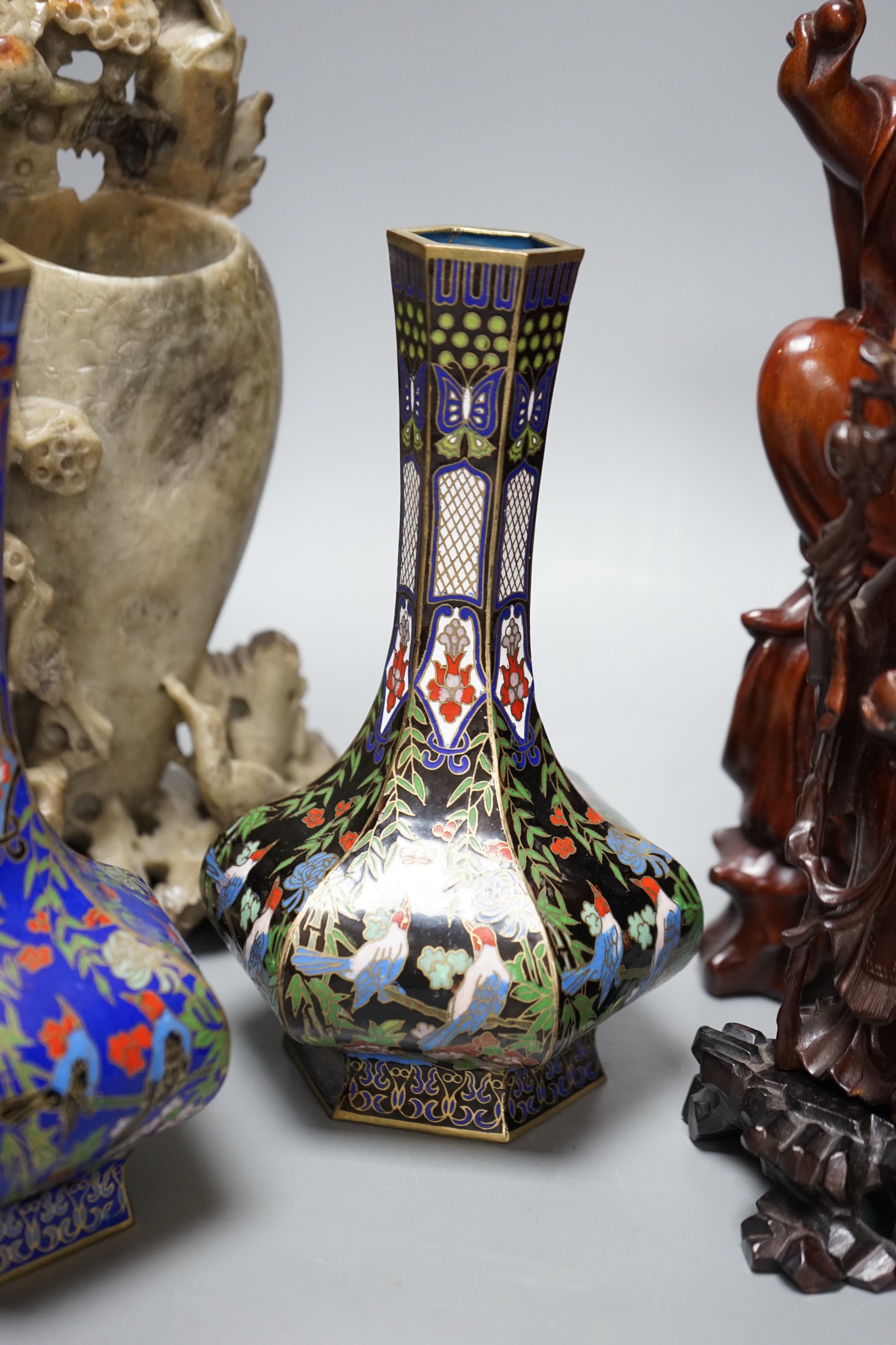 Two Chinese champlevé enamel vases, a soapstone carving and three early 20th century Chinese carved hardwood figures, tallest 26cm